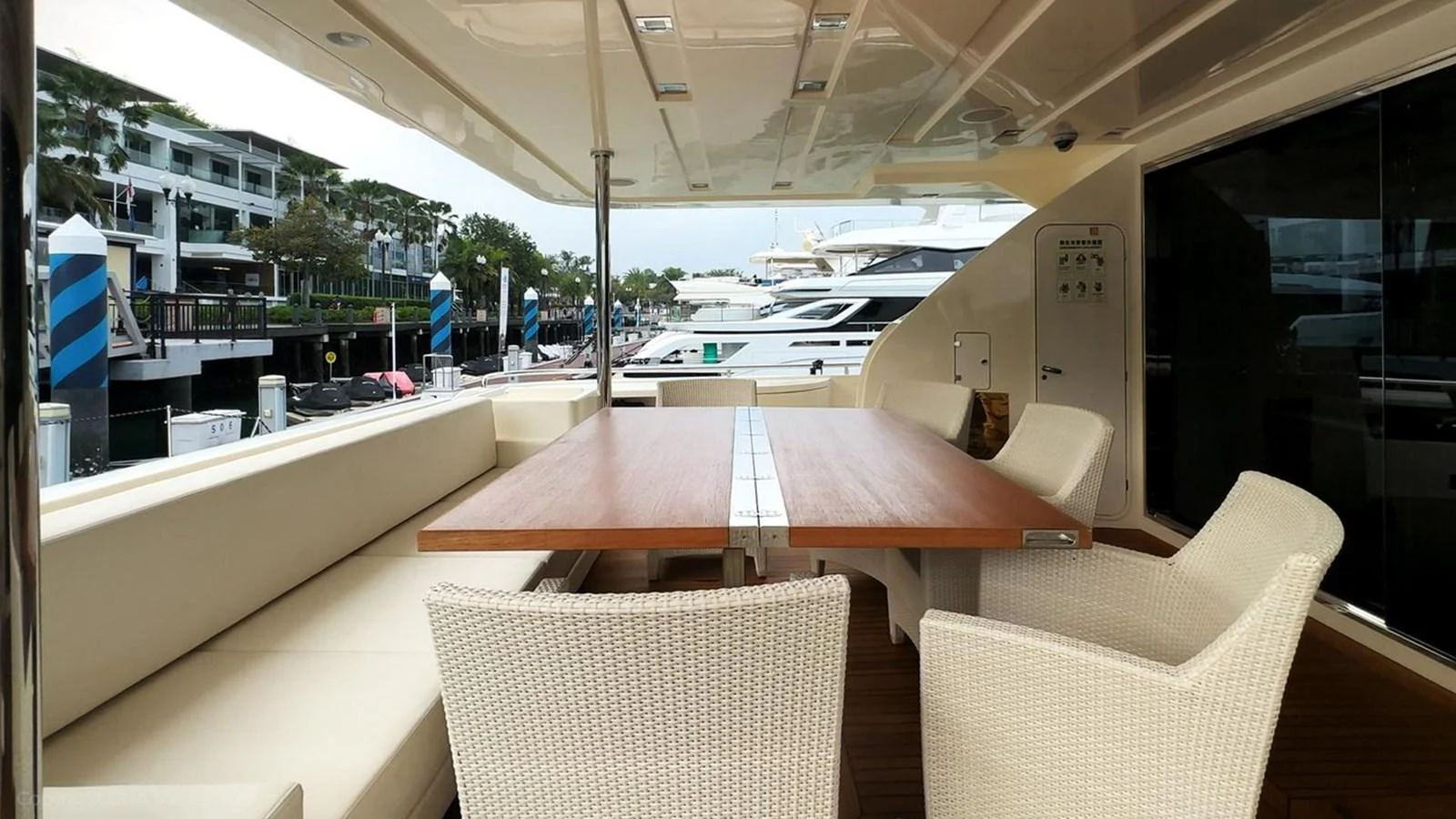 a table and chairs on a balcony aboard OXYGEN Yacht for Sale