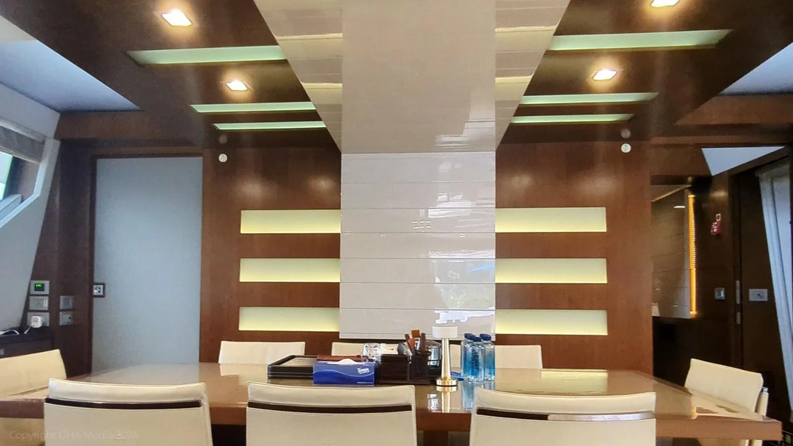 a room with a staircase and tables aboard OXYGEN Yacht for Sale