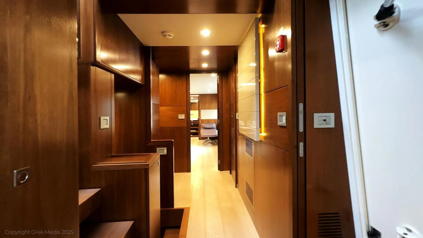 a hallway with wood cabinets aboard OXYGEN Yacht for Sale