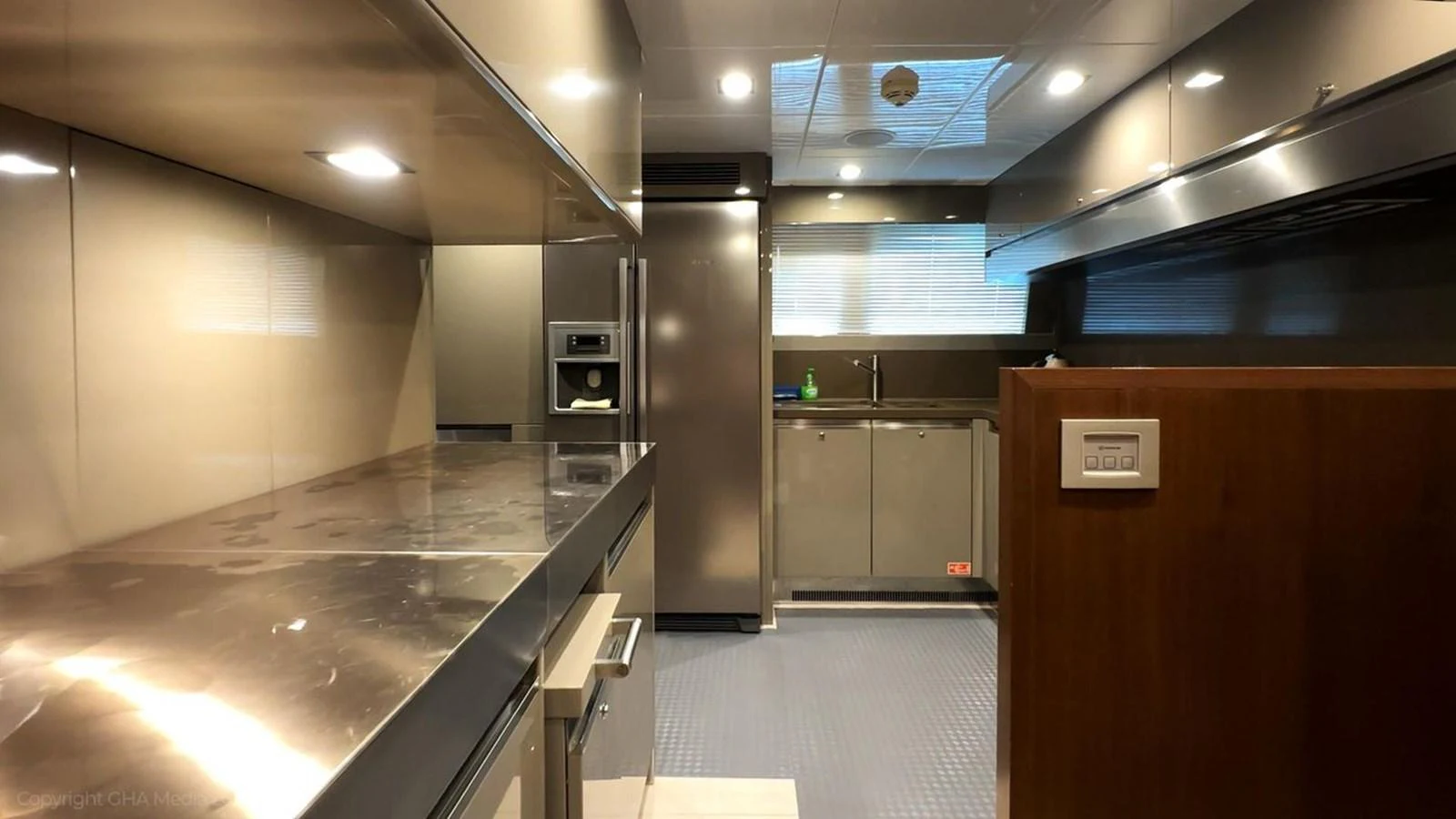 a kitchen with a large refrigerator aboard OXYGEN Yacht for Sale