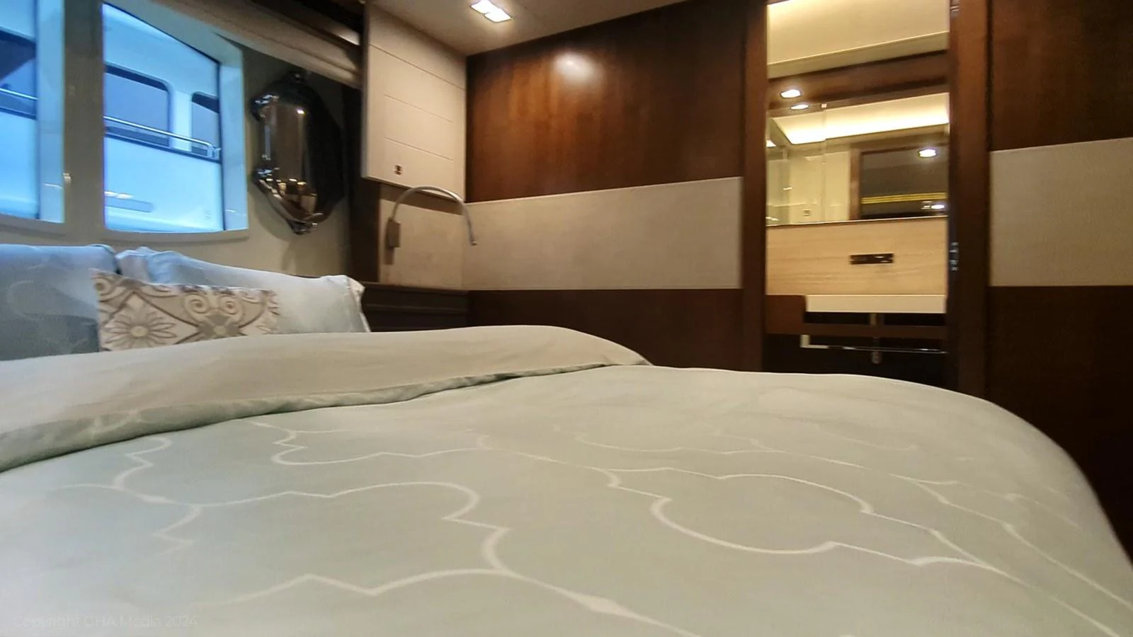 a bed with white sheets aboard OXYGEN Yacht for Sale