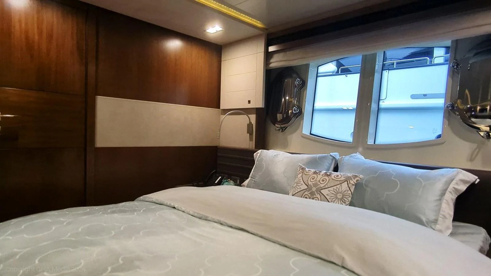 a bed with white sheets aboard OXYGEN Yacht for Sale