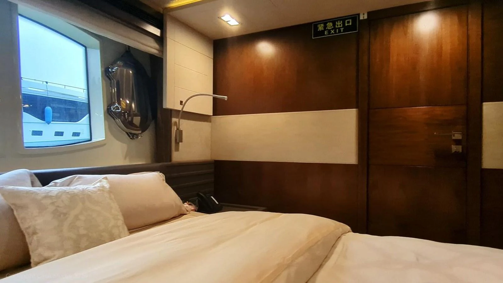 a bed with a television on the wall aboard OXYGEN Yacht for Sale
