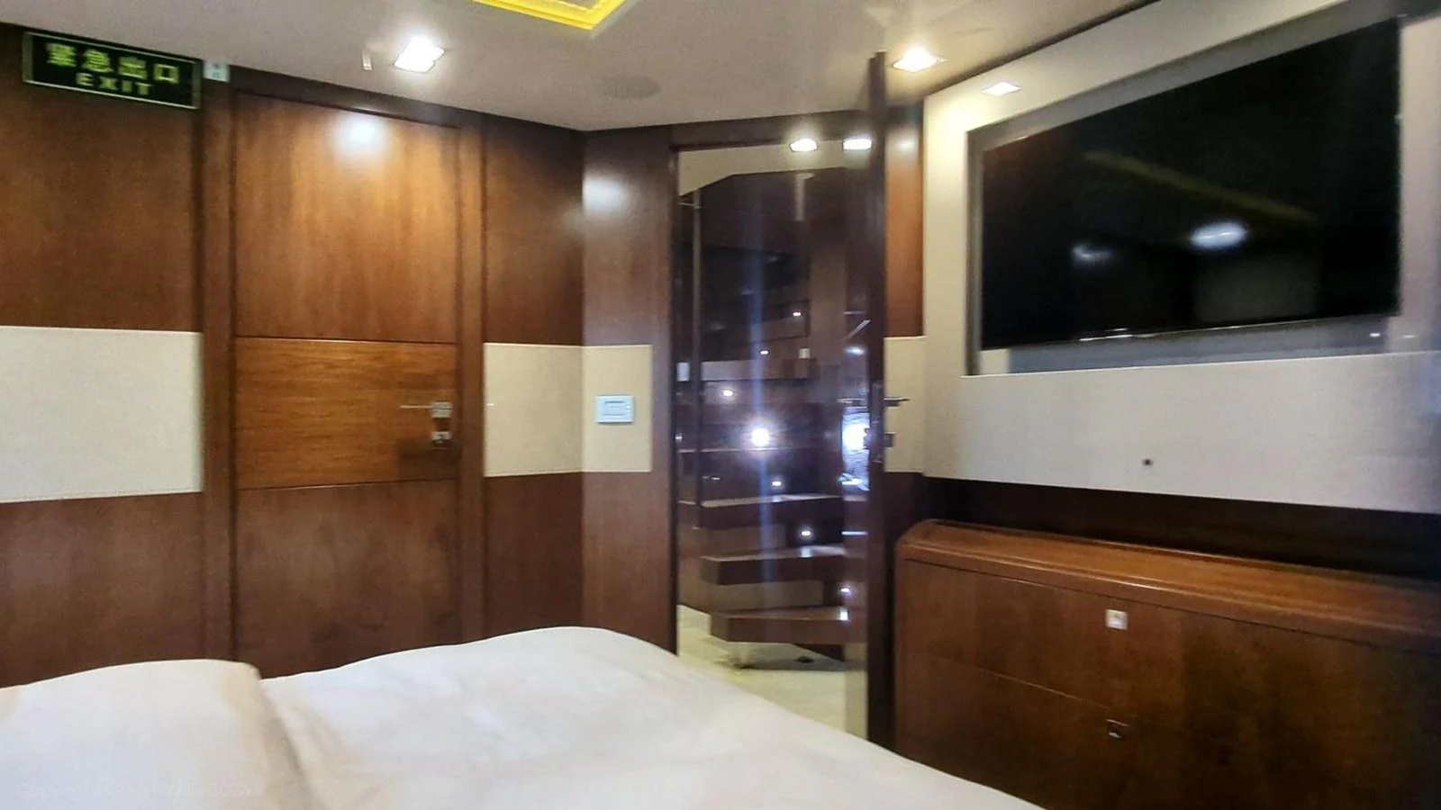 a bed and a television in a room aboard OXYGEN Yacht for Sale