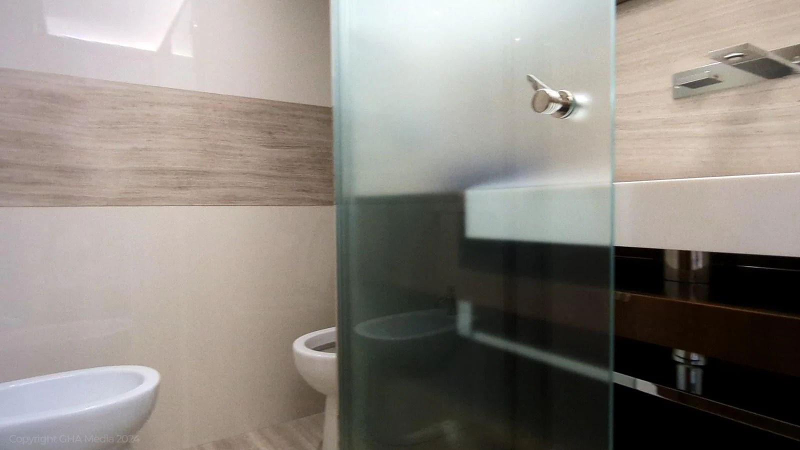 a bathroom with a glass shower aboard OXYGEN Yacht for Sale