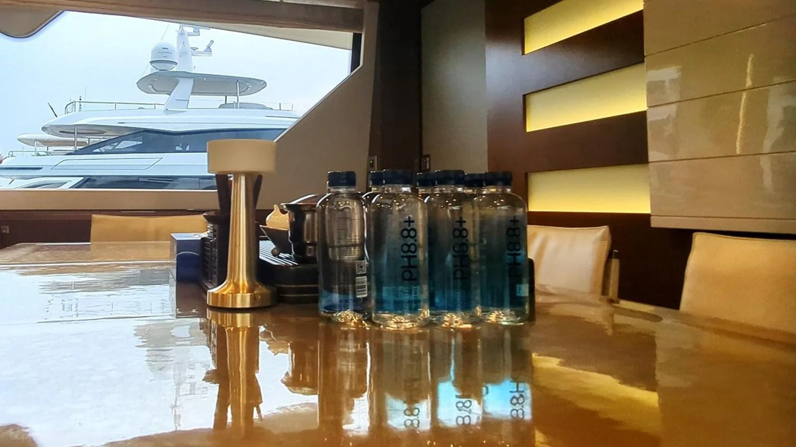 a table with bottles and a lamp aboard OXYGEN Yacht for Sale