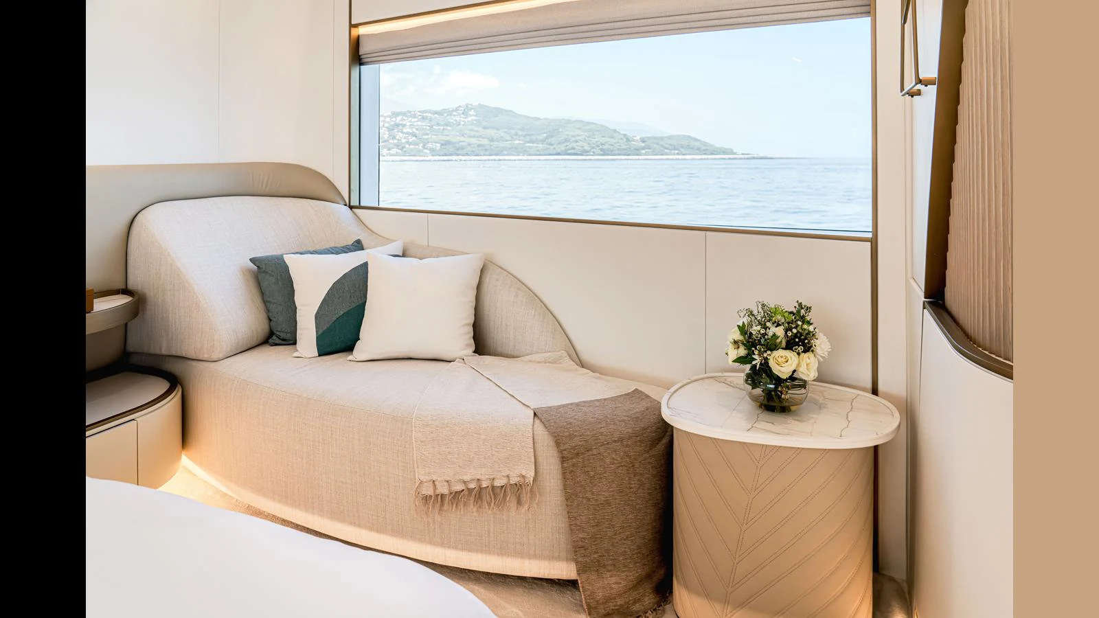 a bed with a white pillow and a vase of flowers on it aboard 100 TERRACE Yacht for Sale