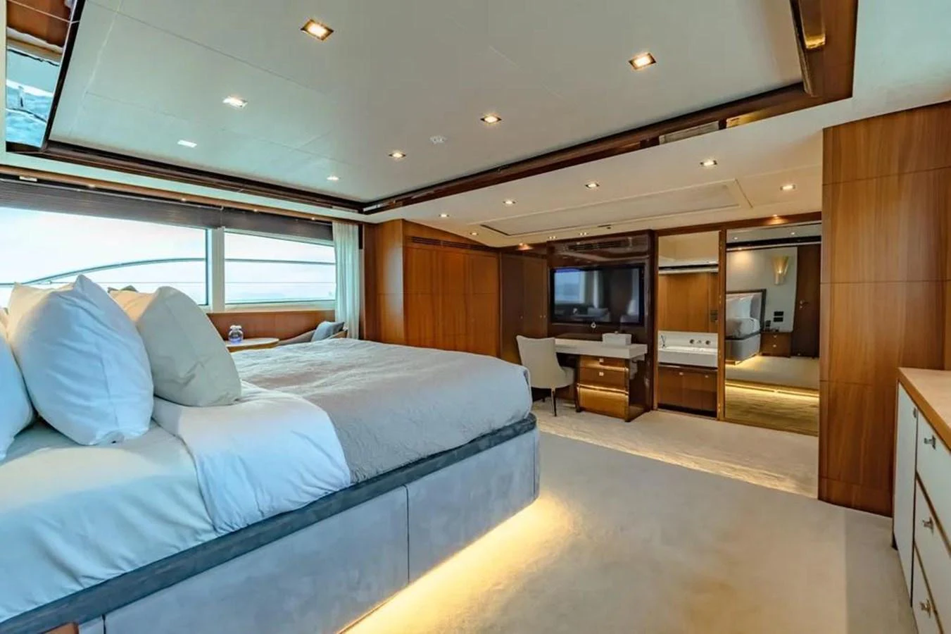 a bedroom with a bed and a desk aboard BLUE MOON Yacht for Sale