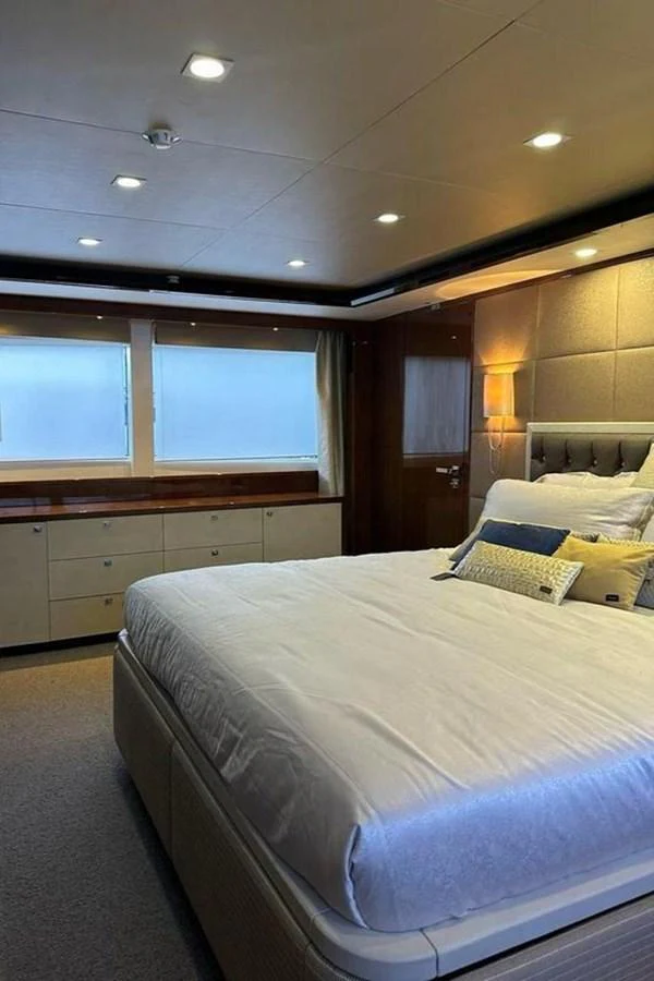 a bedroom with a bed and cabinets aboard BLUE MOON Yacht for Sale