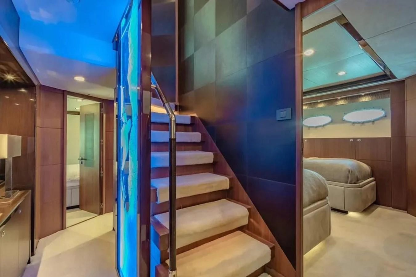 a staircase with blue walls aboard BLUE MOON Yacht for Sale