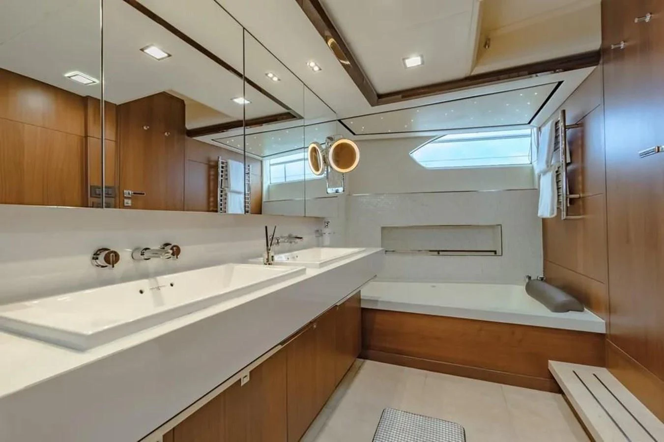 a bathroom with a sink and a large mirror aboard BLUE MOON Yacht for Sale