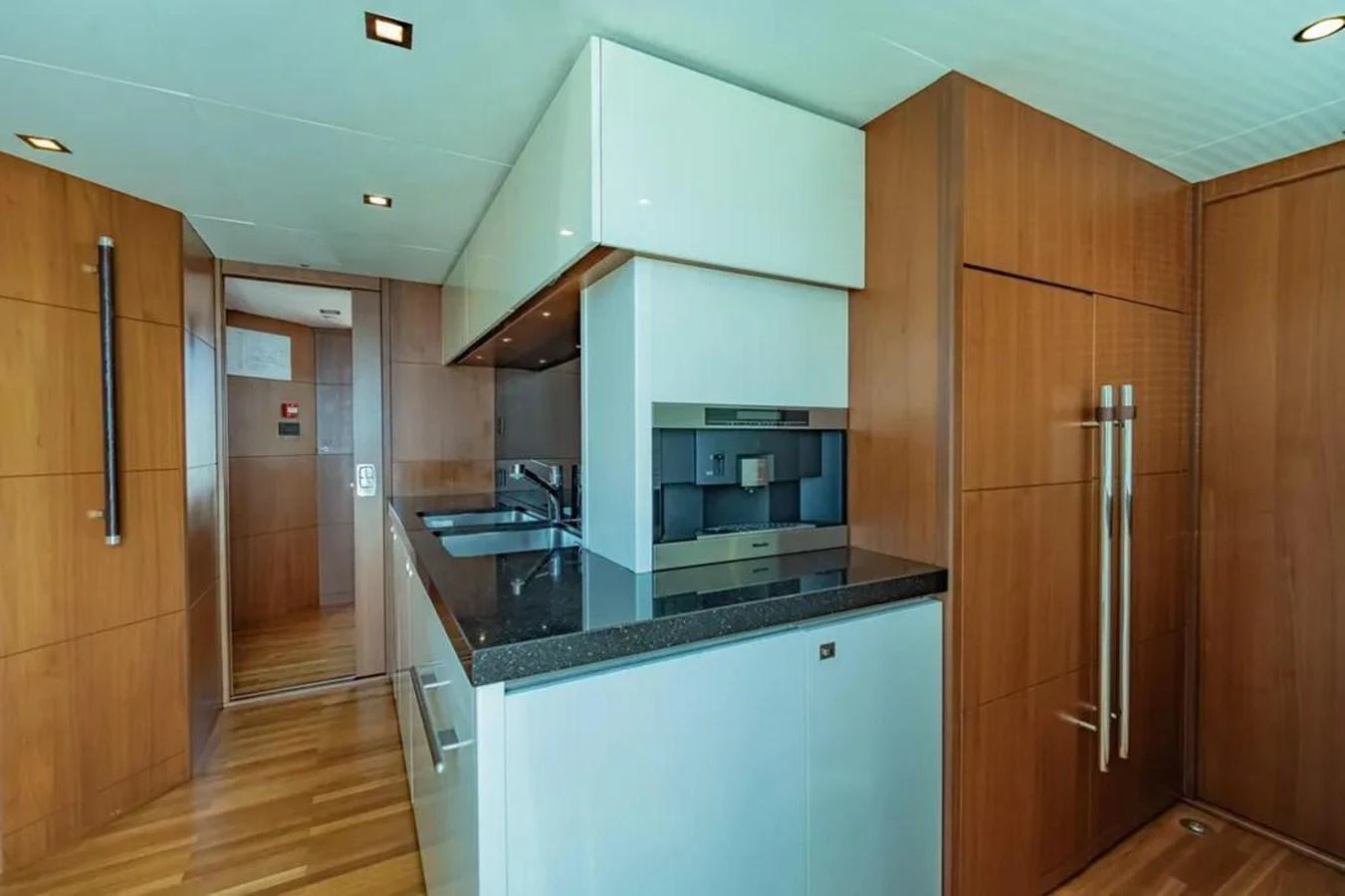 a kitchen with wooden cabinets aboard BLUE MOON Yacht for Sale