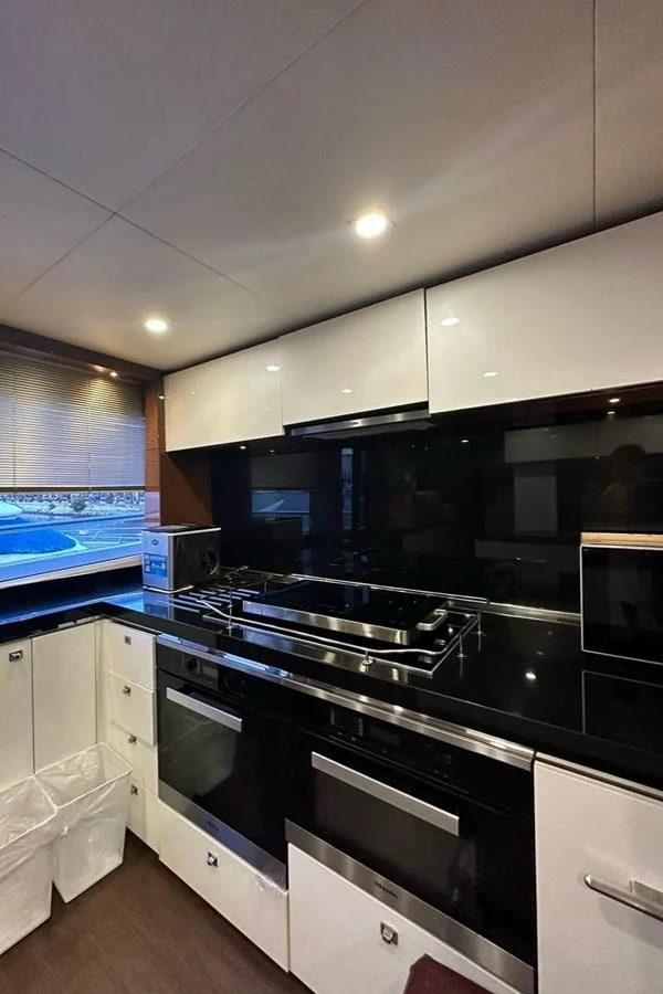 a kitchen with a black stove aboard BLUE MOON Yacht for Sale