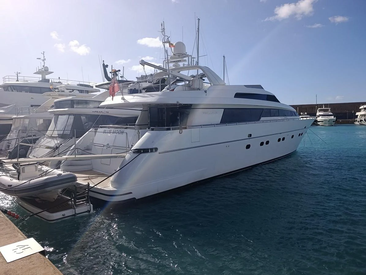 a large white yacht docked at a dock aboard BLUE MOON Yacht for Sale