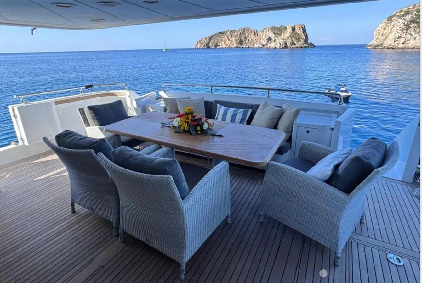 a room with a table and chairs aboard BLUE MOON Yacht for Sale