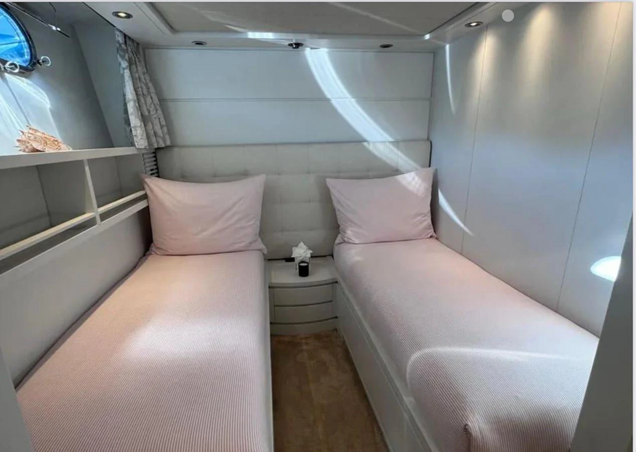 a room with a bed and a mirror aboard BLUE MOON Yacht for Sale