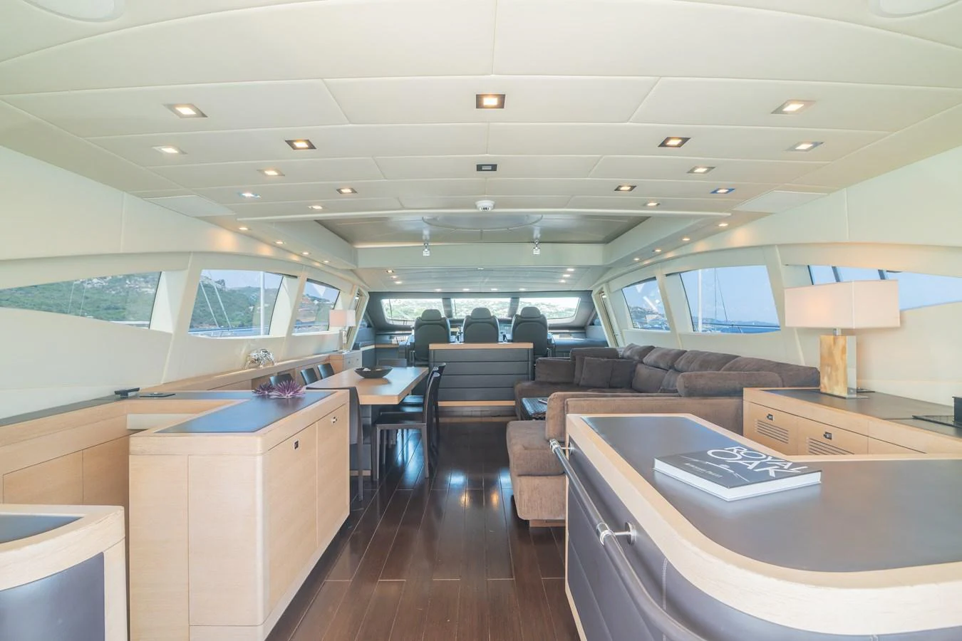 inside of a vehicle with a desk and a couch aboard KAWAI Yacht for Sale
