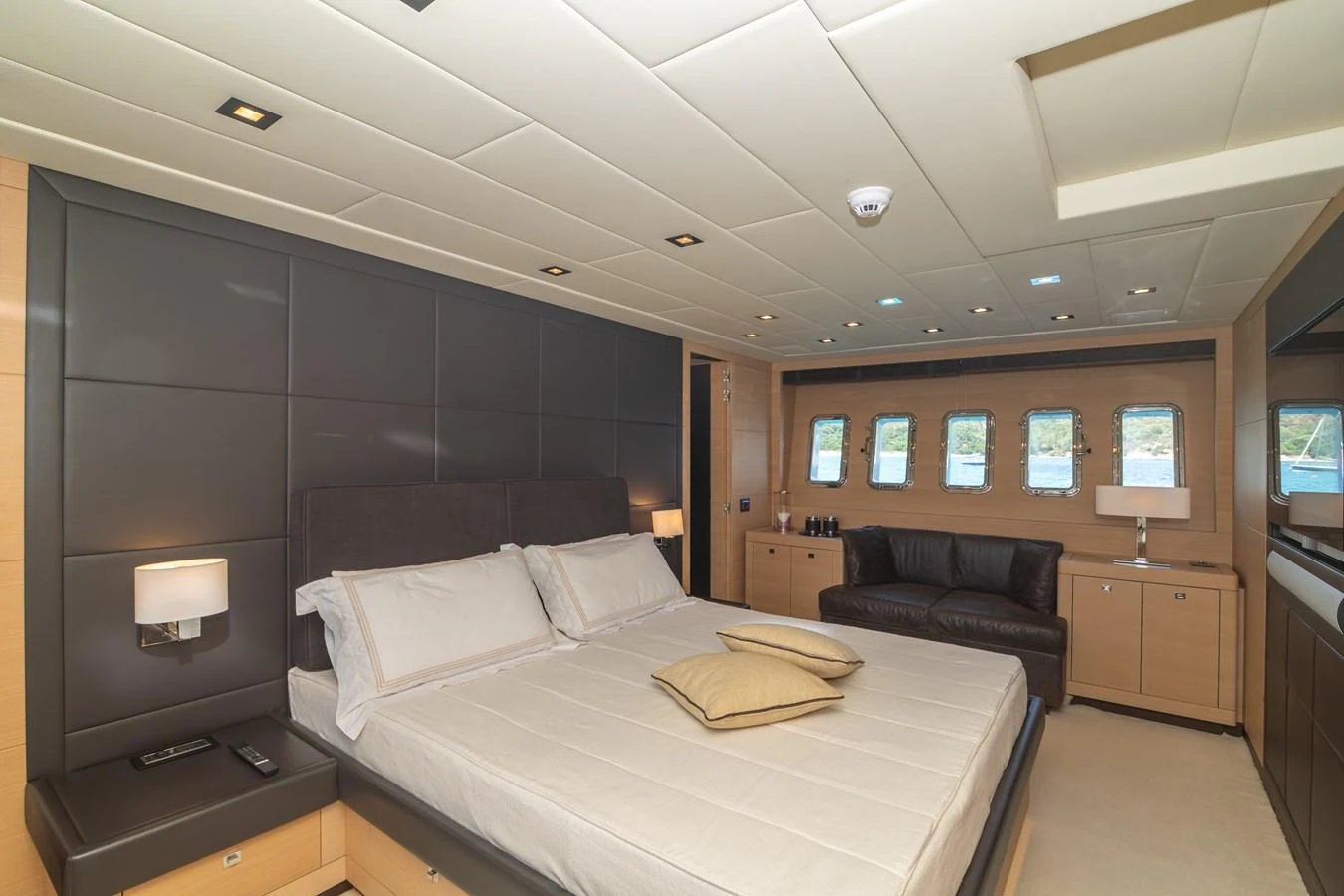 a bedroom with a bed and a couch aboard KAWAI Yacht for Sale