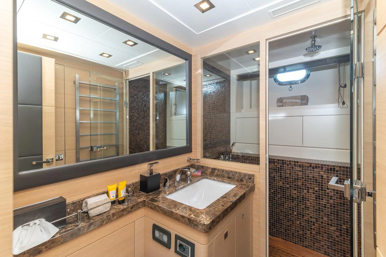 a bathroom with a sink and a mirror aboard KAWAI Yacht for Sale