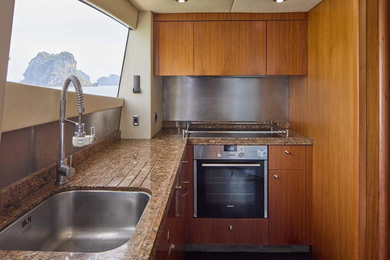 a kitchen with wooden cabinets aboard MAJOR AFFAIR Yacht for Sale