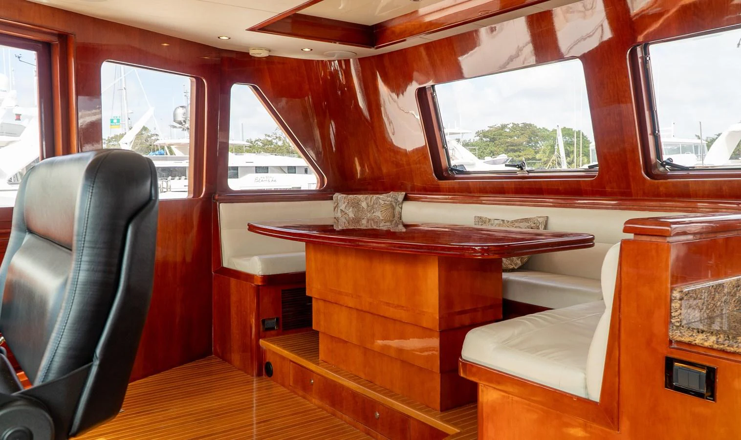 a wooden table in a train aboard JUSMAD Yacht for Sale