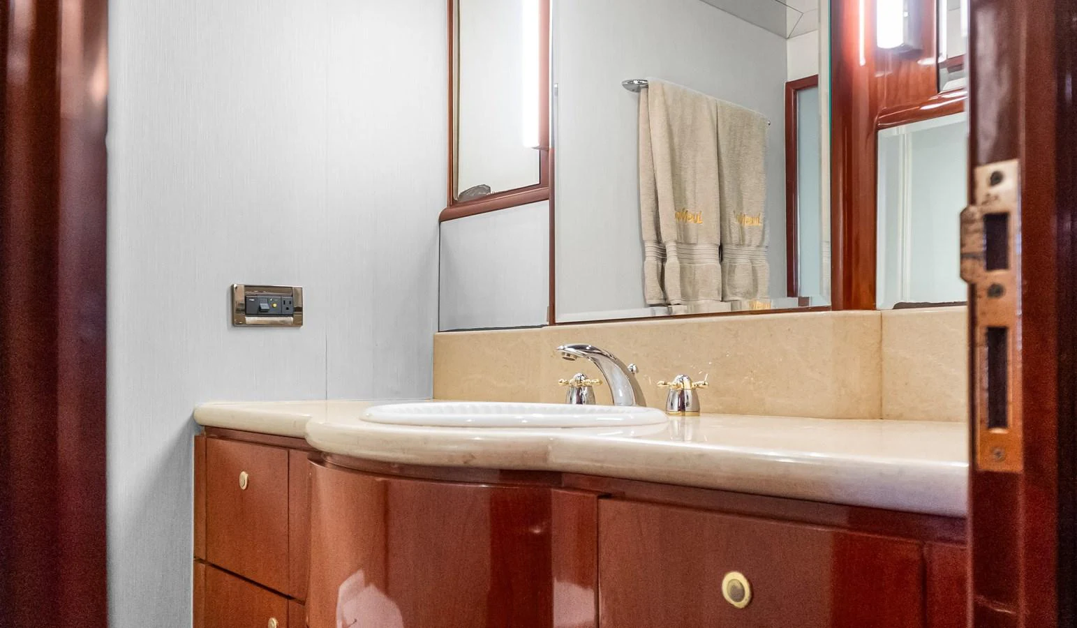 a bathroom with a sink and a mirror aboard JUSMAD Yacht for Sale
