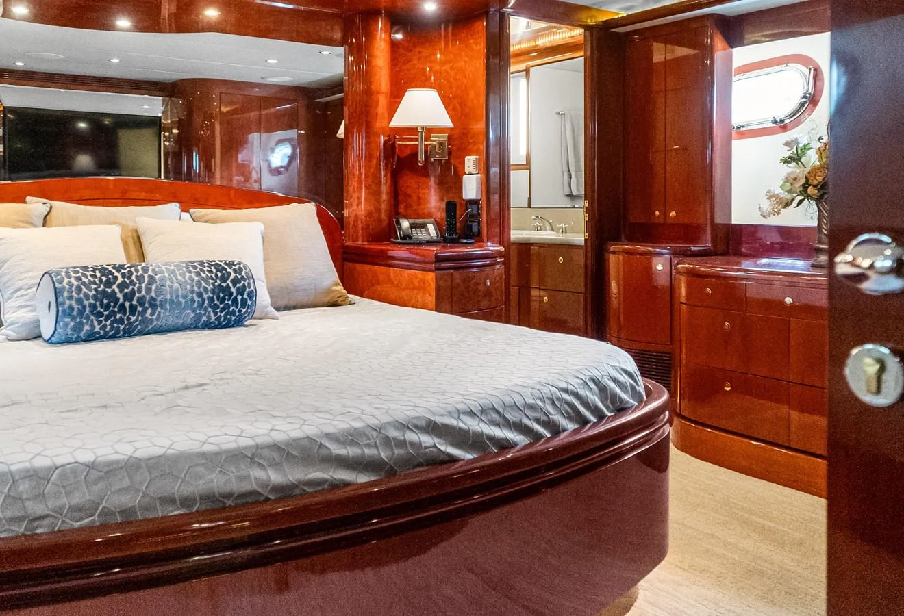 a bed with a white comforter aboard JUSMAD Yacht for Sale