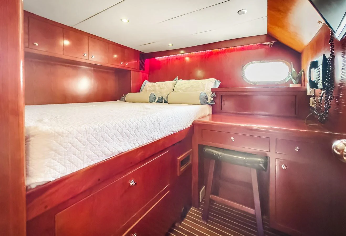 a bed and a desk in a room aboard JUSMAD Yacht for Sale