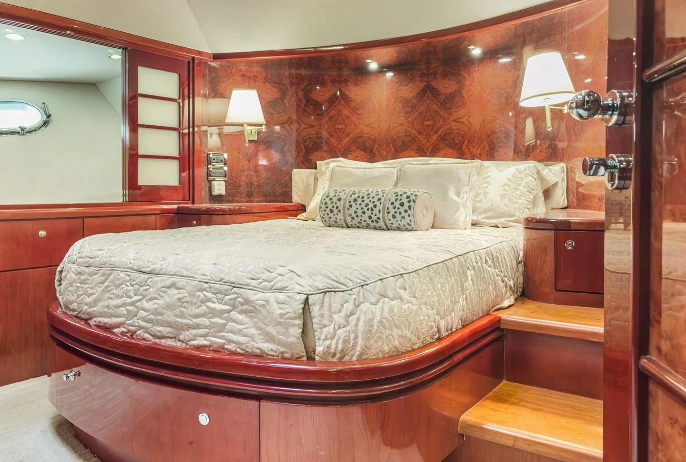 a bed with a white comforter aboard JUSMAD Yacht for Sale