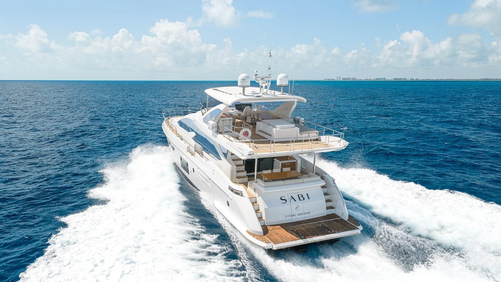 A luxurious yacht cruises through the open sea, showcasing its elegant design and spacious deck areas. aboard SABI Yacht for Sale
