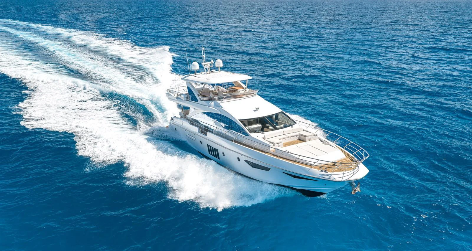 A sleek yacht cruises swiftly through the open sea, showcasing its elegant design and powerful performance. aboard SABI Yacht for Sale