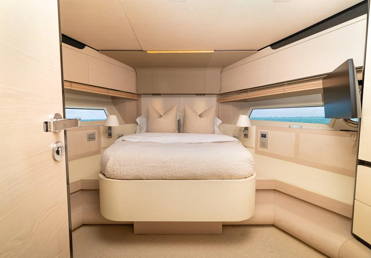 a room with a bed and a mirror aboard SABI Yacht for Sale
