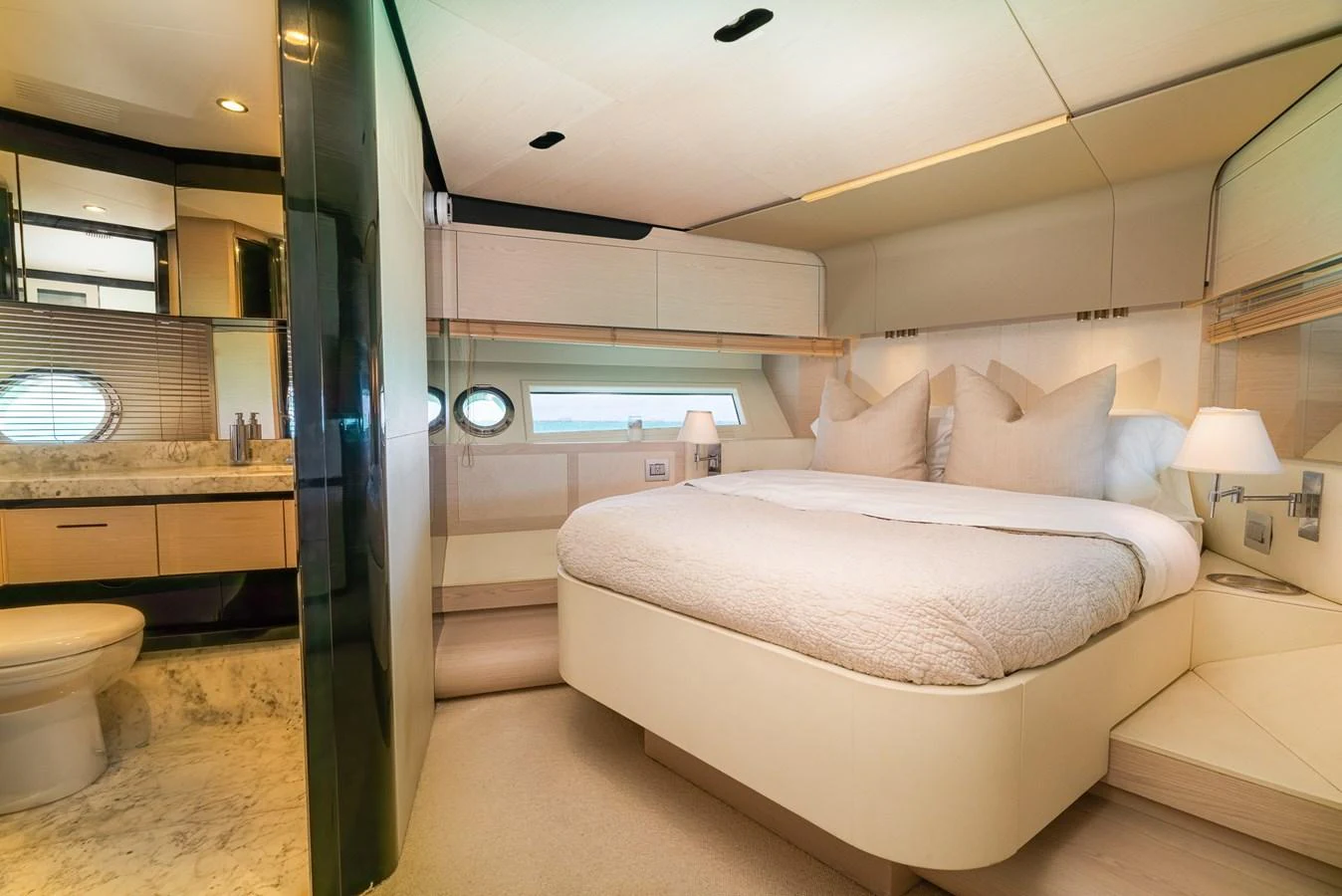 a bedroom with a bed and a mirror aboard SABI Yacht for Sale