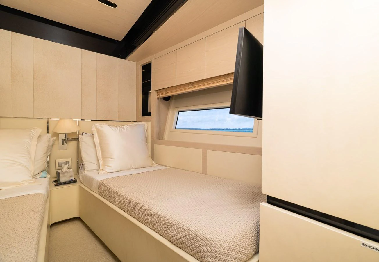 a room with a bed and a television aboard SABI Yacht for Sale