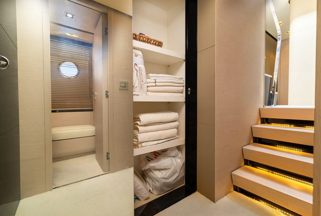 a room with a closet full of white towels aboard SABI Yacht for Sale