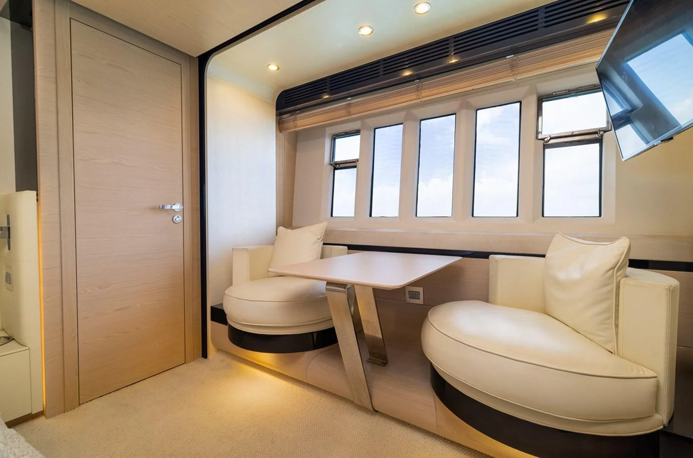 a room with a table and chairs aboard SABI Yacht for Sale