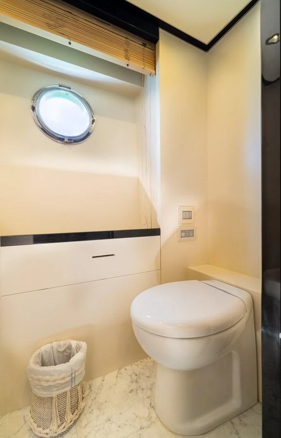 a bathroom with a toilet and a mirror aboard SABI Yacht for Sale