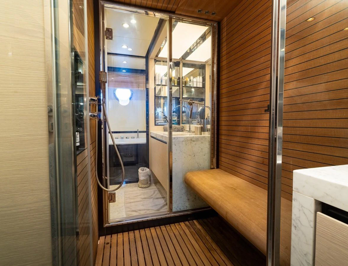 a room with a wood floor and a glass door aboard SABI Yacht for Sale