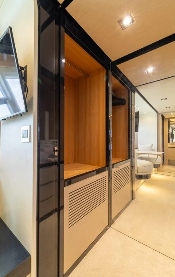 A modern and sleek interior hallway with built-in storage and contemporary lighting. aboard SABI Yacht for Sale