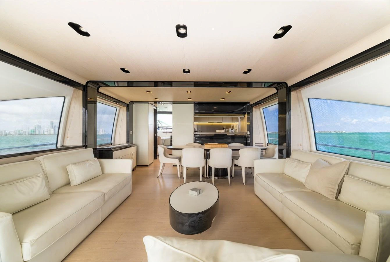 The salon features plush seating and expansive windows offering stunning ocean views. aboard SABI Yacht for Sale