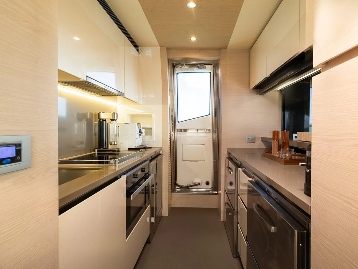 The galley is equipped with modern appliances and sleek cabinetry, offering a functional and stylish space for meal preparation. aboard SABI Yacht for Sale
