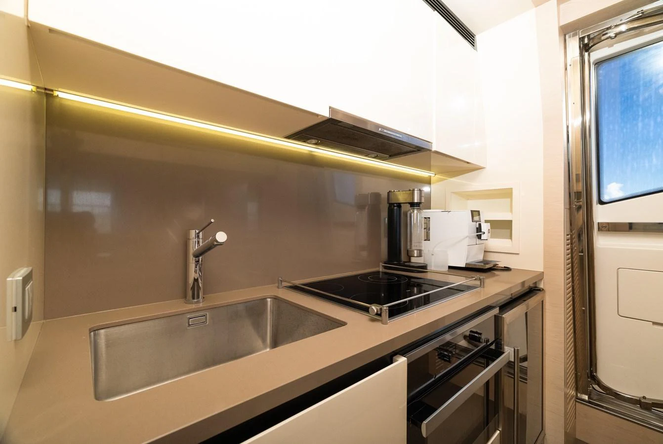 The yacht's galley is equipped with modern appliances and sleek countertops, offering a functional and stylish space for meal preparation. aboard SABI Yacht for Sale