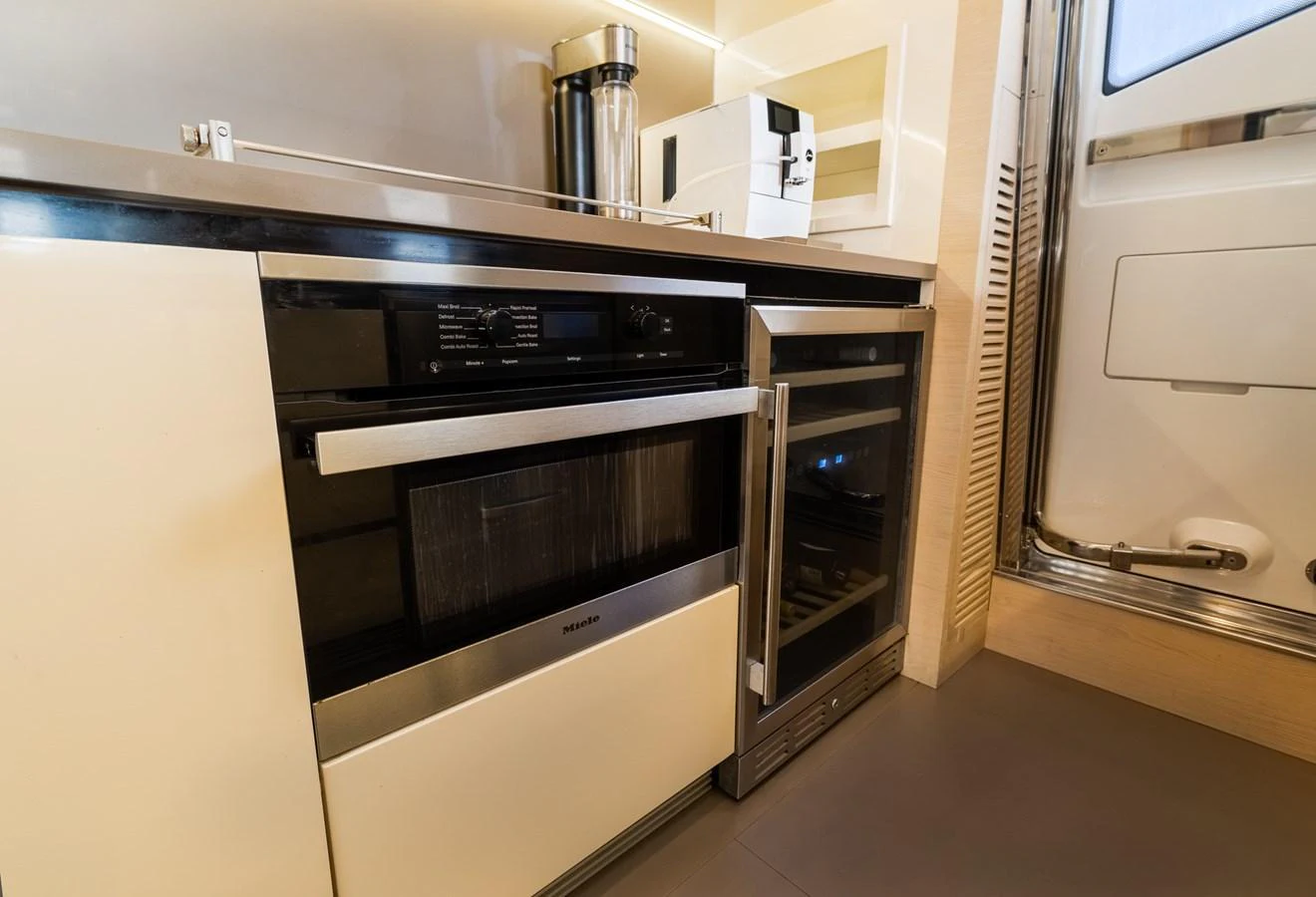 The yacht's galley is equipped with modern appliances and sleek cabinetry. aboard SABI Yacht for Sale