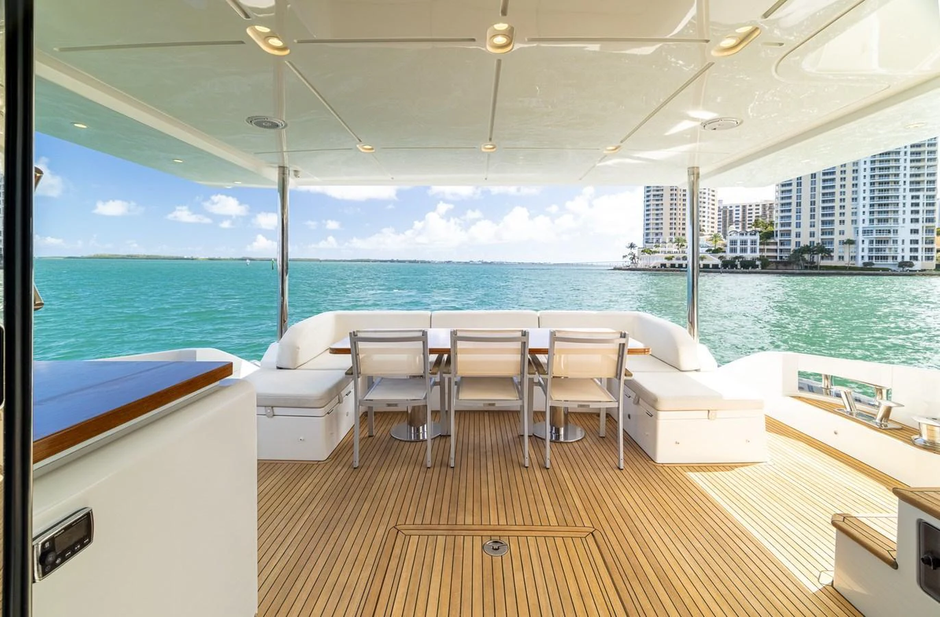 The aft deck offers a spacious and inviting area with a dining setup overlooking the serene waters. aboard SABI Yacht for Sale