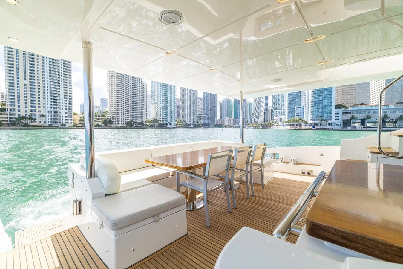 The aft deck offers a spacious and inviting area with a dining table and comfortable seating, perfect for enjoying waterfront views. aboard SABI Yacht for Sale