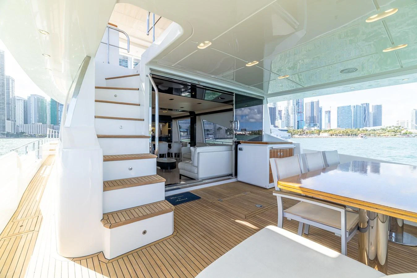 The aft deck offers a spacious and inviting area with a dining table and comfortable seating, perfect for enjoying the views. aboard SABI Yacht for Sale
