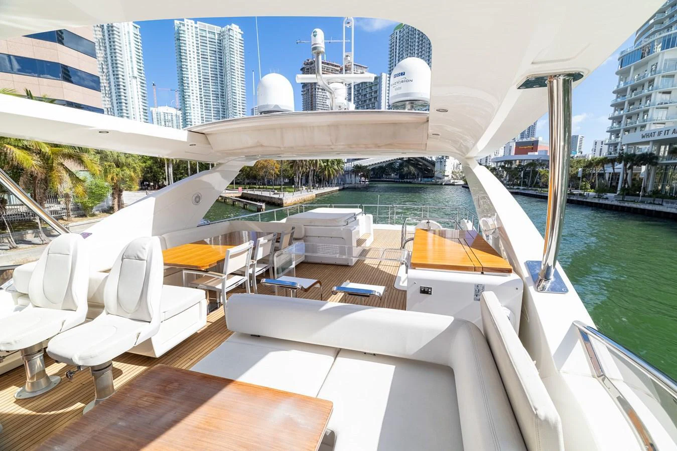 The spacious flybridge offers luxurious seating and dining areas with a stunning waterfront view. aboard SABI Yacht for Sale