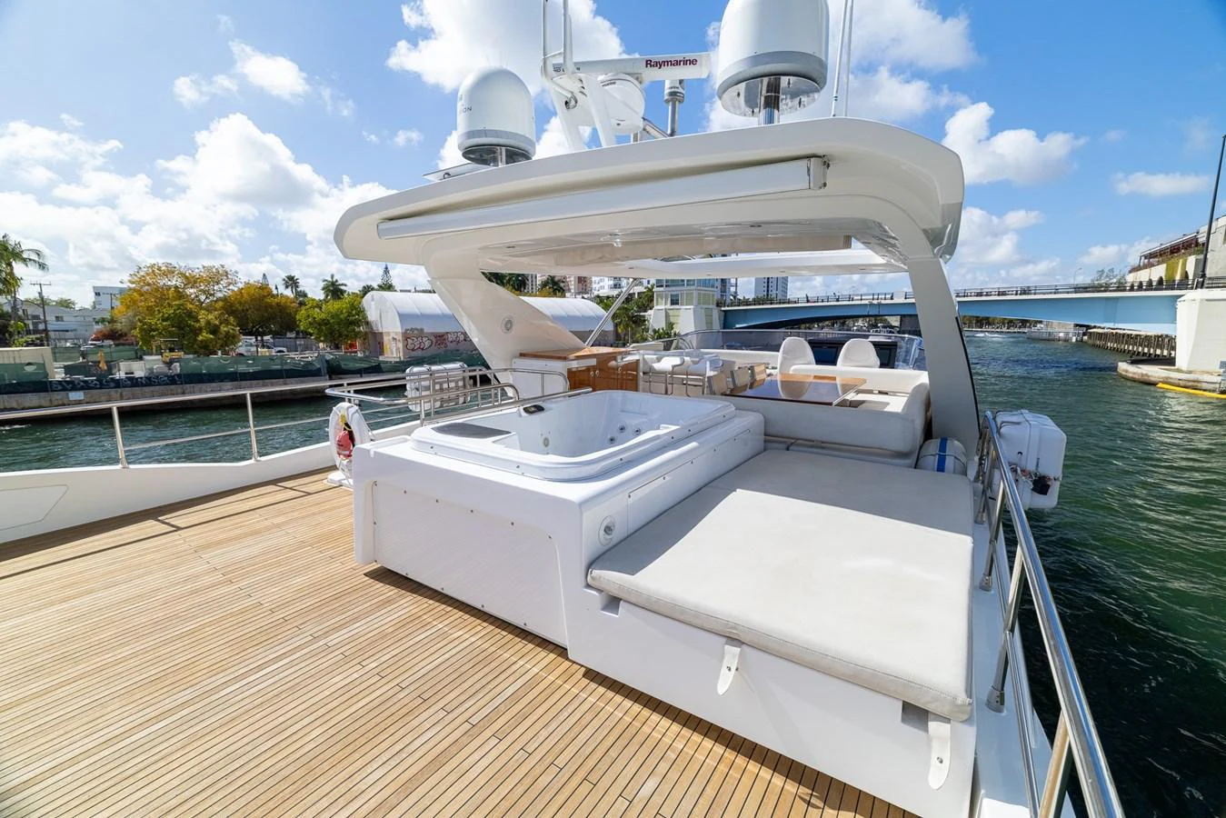 The flybridge features a spacious deck with a jacuzzi and ample seating, perfect for relaxation and entertainment. aboard SABI Yacht for Sale