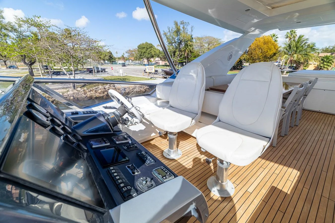 a deck with a table and chairs aboard SABI Yacht for Sale