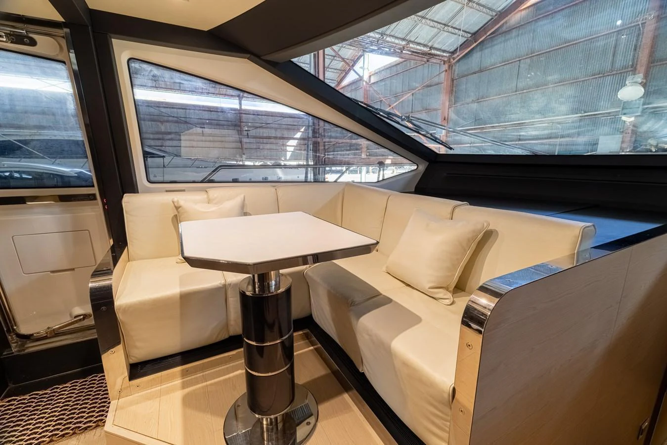 The yacht's salon features a cozy seating area with a sleek table, perfect for relaxation and socializing. aboard SABI Yacht for Sale